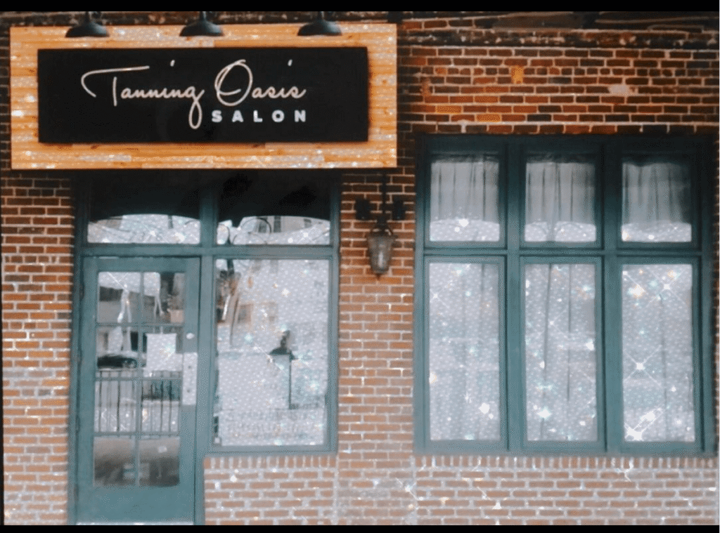 tanning salon storefront exterior with modern signage and brick design