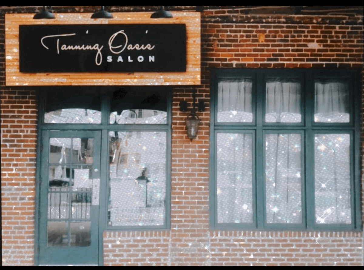 tanning salon storefront exterior with modern signage and brick design