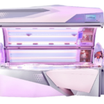 Commercial tanning bed with purple and pink lighting inside the tanning chamber